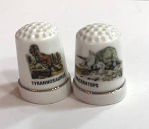 lot 39 image: Two Dinosaur Thimbles. Tyrannosaurus and Triceratops