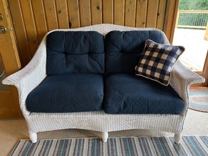 lot 181 image: Wicker Loveseat with Navy Cushions and Plaid Pillow
