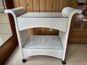lot 183 image: White Wicker Two-Tier Bar Cart with Glass Shelves and Casters