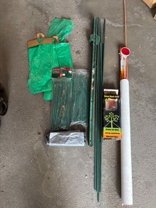 lot 115 image: Outdoor Yard Hardware Lot with Light Stakes, Tree Tie-Downs, Poles, and Bags