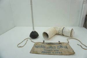 lot 129 image: Toilet plunger, pvc pipe Hoffman nail apron