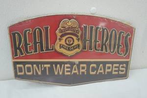 lot 411 image: Metal Sign Real Heroes Dont Wear Capes 12x7.5
