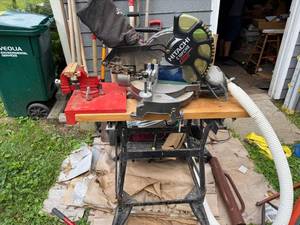 lot 19 image: Hitachi C10FCH2 Laser Compound Miter Saw with Stand and Porter-Cable Sander