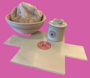 lot 61 image: King Arthur Sourdough Bread Making Set with Banneton, Liner, Ceramic Crock, and Silicone Mat