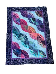 lot 96 image: Colorful Patchwork Quilt with Curved Piecing and Batik Fabrics