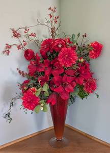 lot 86 image: Large Red Art Glass Vase and Floral Arrangement