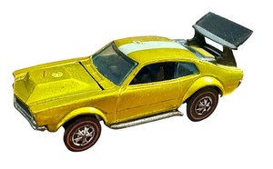 lot 103 image: Vintage Hot Wheels Redlines Mighty Maverick Diecast Car in Metallic Yellow