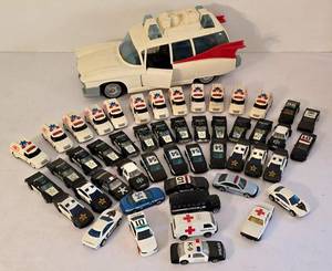 lot 94K image: LR - Collection of Police, Ambulance, and Emergency Toy Cars with Large 14-Inch Columbia Pictures Ambulance