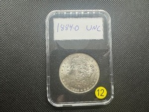lot 12 image: 1884-O Morgan Silver Dollar Marked UNC When Purchased