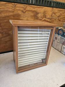 lot 16 image: Buck Knives Locking Display Case with Storage approximately 21 12 inches in height, 18 inches in width, and 10 inches in depth.
