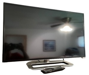lot 215 image: Vizio Flat Screen Television with Stand and Remote