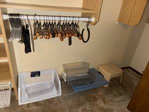 lot 115 image: Closet Organizing Lot with Wooden Hangers and Storage Bins