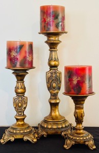 lot 45 image: Three-Tiered Gold Patina Candleholders and Red Candles