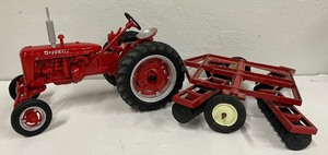 lot 183 image: McCormick Farmall Die Cast Metal Tractor and Tiller