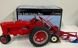 lot 186 image: Precision Series The Little Genius Plow with Plastic Red Trailer McCormick Deering