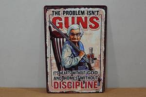 lot 100 image: Novelty Metal Sign - The Problem Isnt Guns
