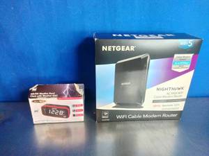 lot 23 image: Netgear 2-in-1 CableLabs DOCSIS 3.0 Cable Modem and Wi-Fi Router and Jensen AMFM Weather Band Clock Radio with Weather Alert