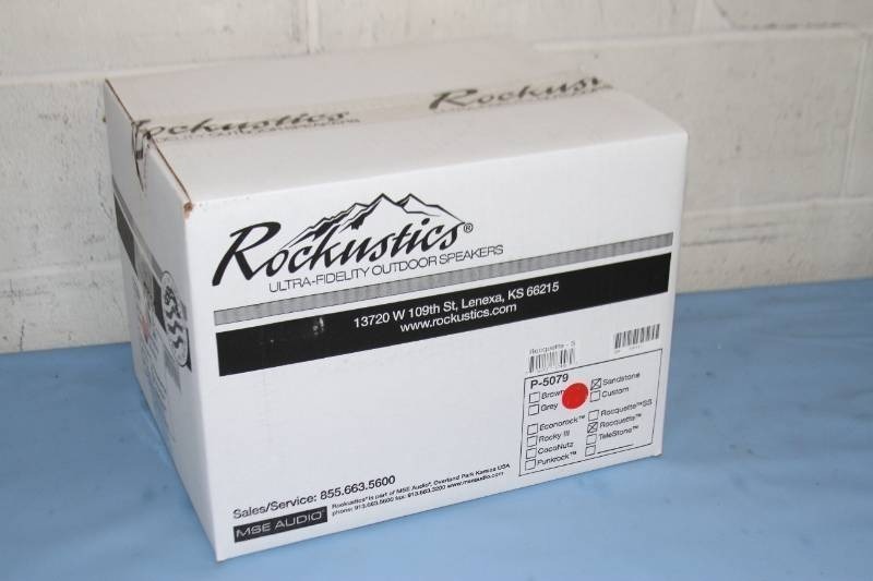 lot 106 image: New in Box Rockustics Rocquette Sandstone Color Rock-Shaped Outdoor Patio  Landscaping Landscape Pro Audio Speaker