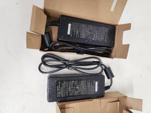 lot 52 image: Lot of 2 Mean Well Laptop AC Adapters and 1 Total Micro 13.5V Li-ion Battery