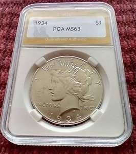 lot 17 image: 1934 Peace Dollar - PGA MS63 - Tough Date
