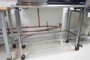 lot 7 image: NSF Stainless Steel Counter with rack on wheels 53 long by 23 wide by 39 tall