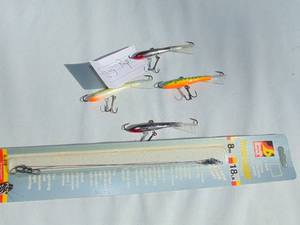 lot 110 image: Mixed Lot of 4 - Rapala Jigging Raps and 3 Pack of Leaders