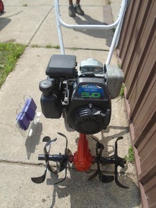 Vintage front tine tiller with Honda 5 hp motor. Tested & works. As shown.