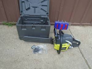 lot 123 image: Ryobi 16 chainsaw. Looks new with chain & carrying case. Tested & works. As shwon.