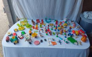 lot 74 image: Mixed vintage Fisher-Price toys including vehicles, figures, and accessories