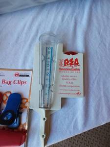 lot 125A image: Runestone Electric Association Rain Gauge, Culinary Elements Bag Clips, Camping Water Bag, Cheese Grater, and Other Kitchen and Utility Items