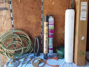 lot 134 image: Garden Tools and Supplies including Hose Reel, Weed Barrier, and Sprinklers