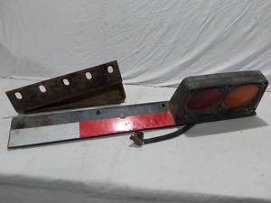lot 213 image: Tail light assembly with bracket and reflective strip