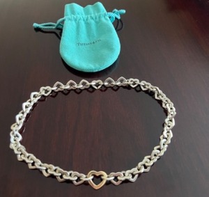 lot 1 image: Tiffany & Co. Silver and Gold Heart Link Necklace with Pouch
