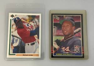 lot 184 image: 1984 Donruss Kirby Pucket Rookie Card And Michael Jordon Baseball Card (Both In Protective Sleeves)