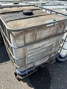 lot 1100 image: Used 275 Gallon IBC Tote Tank with Metal Cage