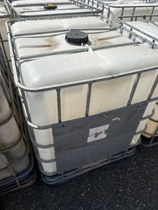 lot 1101 image: Used 275 Gallon IBC Tote with Metal Cage