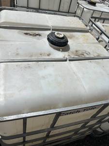 lot 1106 image: Used Plastic IBC Liquid Storage Tote with Metal Cage