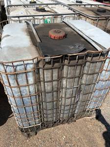 lot 1200 image: Used 275-Gallon Tote Tank with Metal Cage