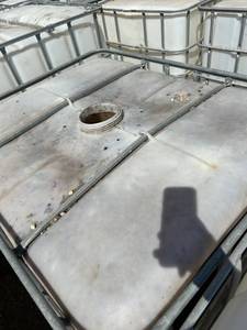lot 1206 image: Used Plastic IBC Tote Tank with Metal Cage