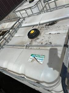 lot 1208 image: Used 275 Gallon IBC Tote with Metal Cage