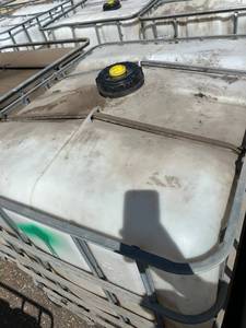 lot 1301 image: Used 275 Gallon IBC Tote Tank with Metal Cage