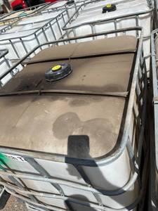 lot 1302 image: Used 275 Gallon IBC Tote Tank with Metal Cage