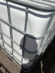 lot 1303 image: Used 275 Gallon IBC Tote with Metal Cage