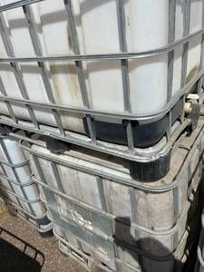 lot 1304 image: Stack of Used 275-Gallon IBC Tote Tanks with Metal Cages