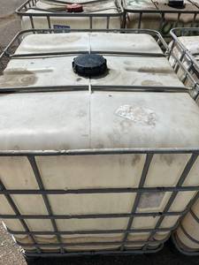 lot 1400 image: Used IBC Tote Tank with Metal Cage 275 Gallon