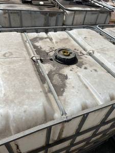 lot 1406 image: Used 275-Gallon IBC Tote with Metal Cage