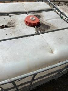 lot 1408 image: Used 275-Gallon IBC Tote with Metal Cage