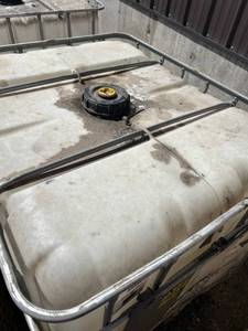 lot 1410 image: Used 275 Gallon IBC Tote Tank with Metal Cage