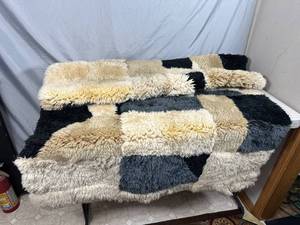 lot 29 image: Brazilian Made Rug - Sheepskin Alpaca We arent sure.