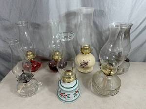 lot 55 image: 7 Vintage Glass Oil Lamps  Hurricane Lamps